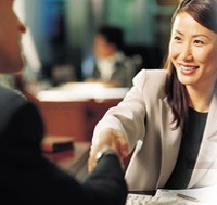 Woman shaking hands after a great job interview.