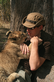 Volunteer and lion cub