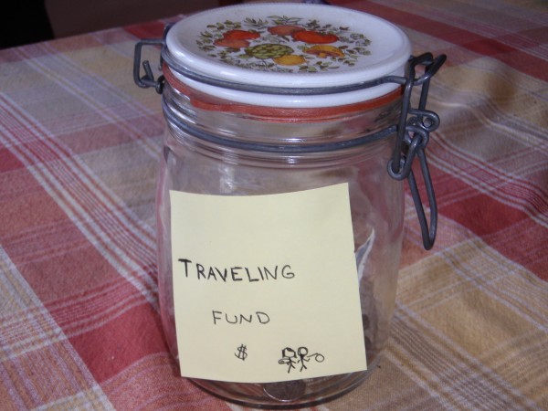 a photo of a tip jar holding money that will be spent to travel and volunteer abroad.
