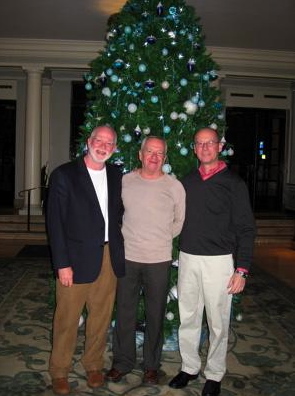 Randy LeGrant, Kevin Morgan, and Jim Miller in front of a Christmas tree at the Park Lane Hotel in London, England.