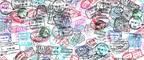 A passport page with dozens of visa stamps on it.