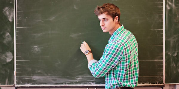 TEFL Plus teacher in a classroom writing on the chalkboard