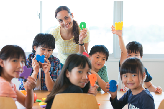 A teacher with her students in her classroom.